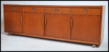 A 1970's retro teak low sideboard dresser unit of Danish inspiration. Raised on castors to the