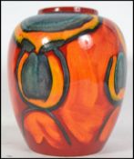 A Poole Pottery Delphis vase, the outside decorated with a red, blue and orange abstract design,