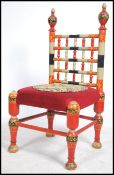 A stunning Indian handpainted red opium / hall chair raised on turned legs with overstuffed velour