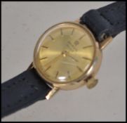 A 9ct gold Marvin Revue Swiss movement ladies cocktail watch having leather strap. Marked to