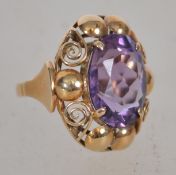 A believed Victorian 585 / 14ct gold and amethyst dress ring. The large oval amethyst being claw