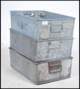 A group of three vintage industrial factory aluminium parts bins.