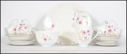 A retro Queen Anne Bone China 21 piece tea service dating back to 1965. Decorated with blue