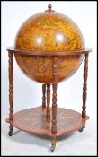 An antique style cocktail drinks globe having with applied terrestrial design with flip top lid