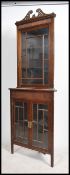 An Edwardian mahogany twin section glazed display corner cabinet. Raised on squared legs with twin