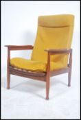 A retro mid century Danish inspired armchair having show wood angular teak frame with with swept