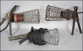 A collection of 3 vintage mid century Industrial hand held cage trouble / inspection lamps each with