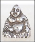 A silver white metal cast figure of a sitting Buddha. Rubbed silver marks to the base, tests as