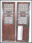 A pair of 20th century lacquered Chinese doors / screens the upper panels decorated with lattice