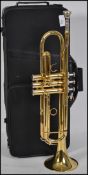 A cased 20th century brass trumpet with mother of pearl buttons. Inscribed Gear 4 Music to main