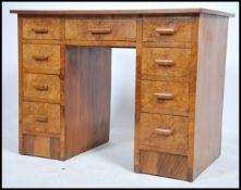 A 1930's Art Deco walnut twin pedestal desk having a red faux leather writing skiver. Central