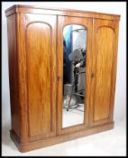 A Victorian mahogany linen press - triple wardrobe