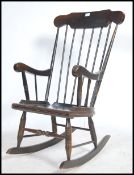 An antique style beechwood rocking chair being raised on turned legs with sleigh runners with