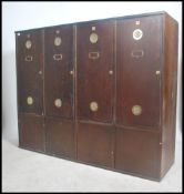 A large 20th century Industrial panel wood locker unit having multiple locker doors with vented