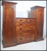 A Regency - Victorian mahogany compactum triple wardrobe combination. Raised on a plinth base having