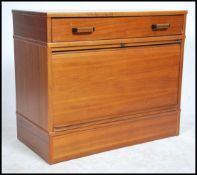A retro 20th century walnut tambour fronted office cabinet having a plinth base with pull up tambour