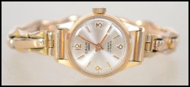 An 18ct gold ladies Cauny Prima Swiss made 17 ruby movement dress / cocktail watch having a silvered