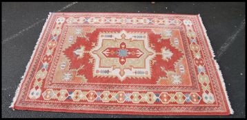 A good wool carpet on red ground having a tribal d