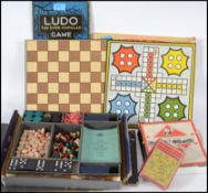 A vintage 20th century games compendium with multiple games and pieces together with a group of