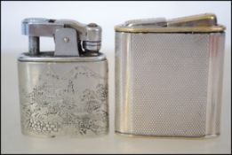 Two sterling silver cased lighters, the first having an engine turned case and the other having a