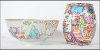 A 19th century Chinese famille rose fruit bowl decorated with scenes of merchant men and scholars