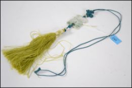 A 20th century jade pendant of carved fish detail