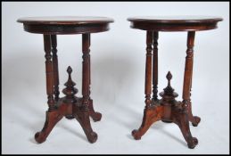 A pair of Victorian style hardwood circular lamp tables. Each raised on turned legs with finial