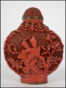 A Chinese red cinnabar lacquer snuff bottle and st