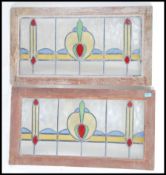 A pair of 19th century Victorian Art Nouveau stained glass window panels held within wooden frames.
