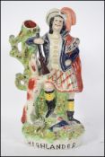 A 19th century Scottish flatback figurine entitled ' Highlander ' being raised on plinth base with