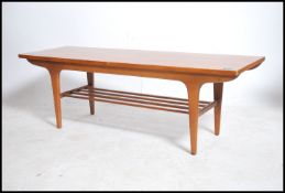 A 1960's retro Danish influenced teak wood rectangular coffee occasional table, Raised on tapered