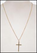 A 9ct gold rolo link necklace chain with spring hoop clasp having a 9ct gold crucifix pendant. Total