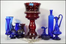 A collection of blue glass to include vases, ewers etc along with overpainted Bohemian blue glass.