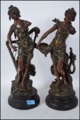 A pair of classical early French bronze figurines of musicians each being raised on socle plinth