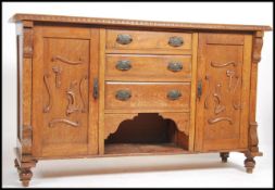 A 19th century oak Arts & Crafts sideboard / dresser having unusual organic carved embellished