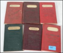 A collection of 6 early to mid century canvas bound grocer books, all with tooled retailers notation