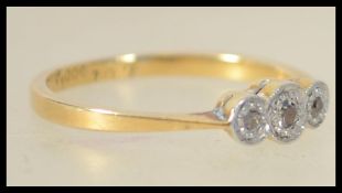 An 18ct gold and platinum 3 stone diamond ring eac