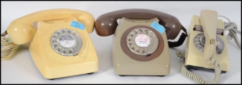 A group of three vintage retro telephones. These 1960's 1970's designed phones include a dial
