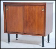 A 1970's teak wood small cabinet being raised on e