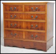 A regency style yew wood chest of drawers being ra