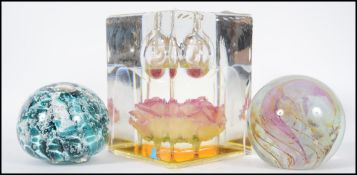 A collection of three paper weights to include an