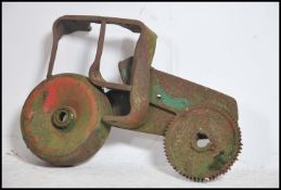 An unusual upcycled salvage folk art sculpture of a agricultural tractor being salvaged from