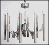 A 20th century retro ceiling chandelier constructed of cylindrical polished steel drops united by