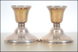 A pair of silver hallmarked stub candlesticks by W