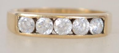 A 9ct gold 5 stone diamond ring being channel set