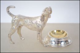 A silver plated salt in the form of a dog.