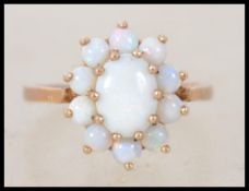 A vintage hallmarked 9ct gold and opal cluster ring. Hallmarked for London. Weight 3.3g. Size M.5.
