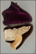 A 19th century cased meerschaum pipe end in the fo