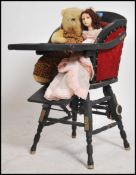 An early 20th century childs high chair in ebonise