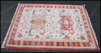 A good wool carpet on cream ground having a tribal